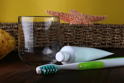 photo of toothbrush, toothpaste, glass, sponge, starfish, and basket