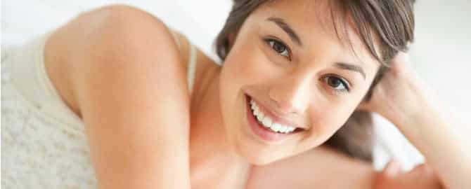 Woman smiling laying down with no headache